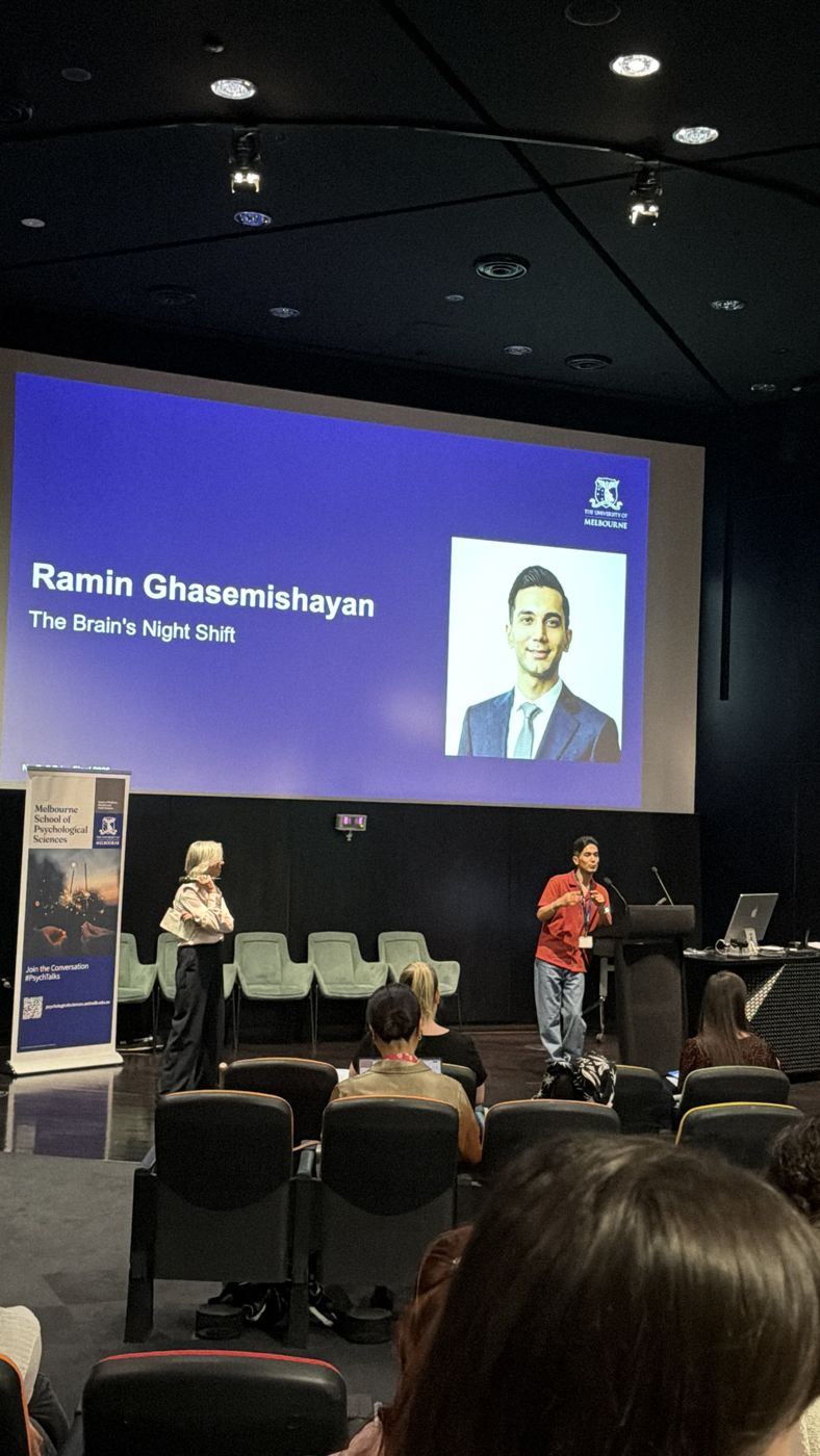 Ramin presenting The Brain's Night Shift on stage at the No-Bell Prize final